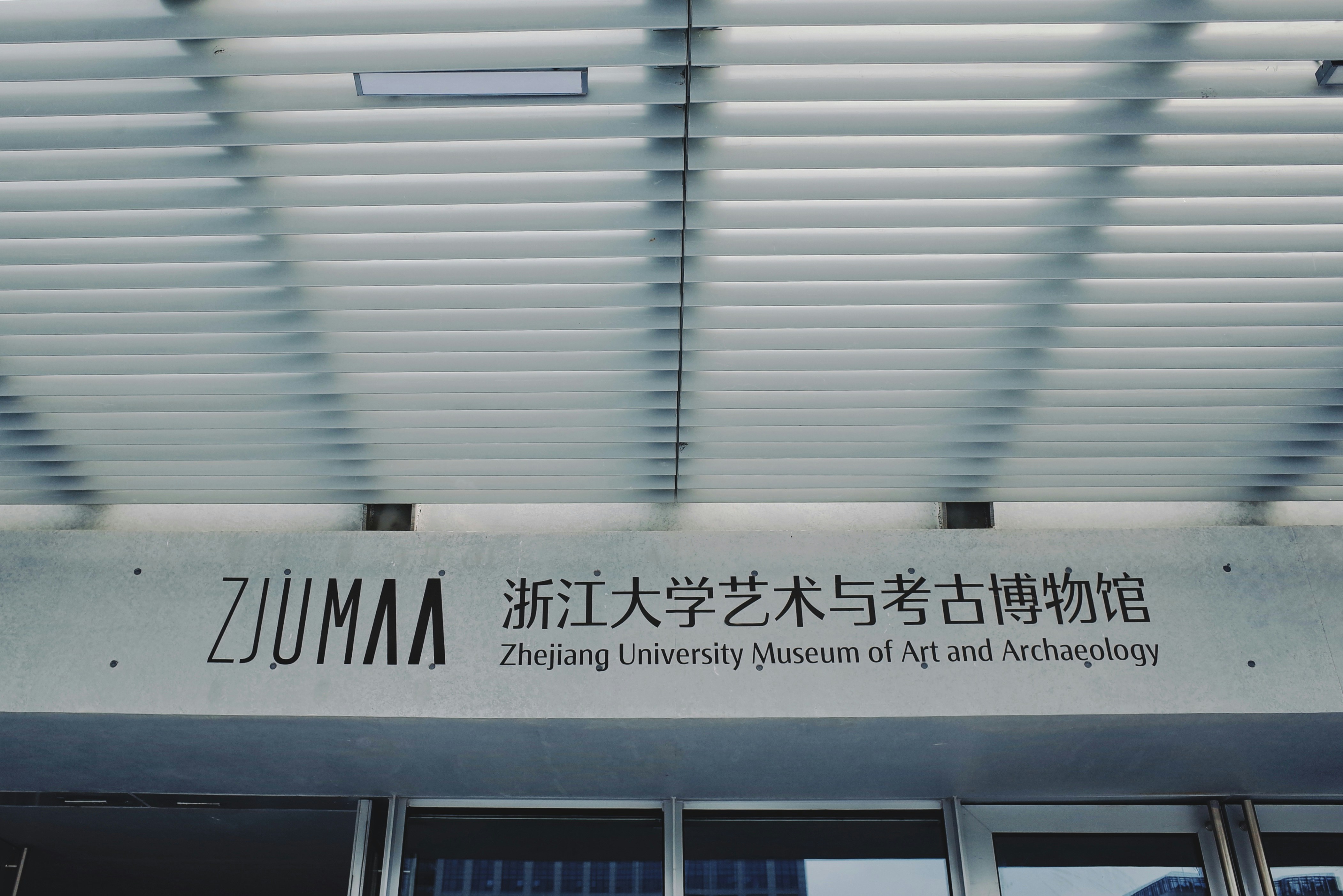 a building with a sign above it that says zummm