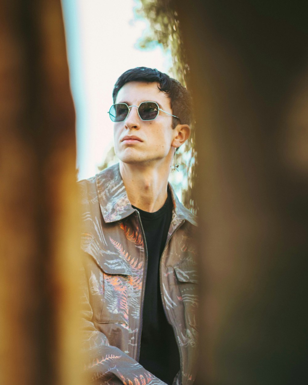 a man wearing sunglasses and a leather jacket