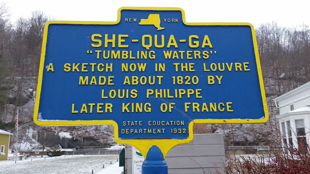 a blue and yellow sign in front of a building