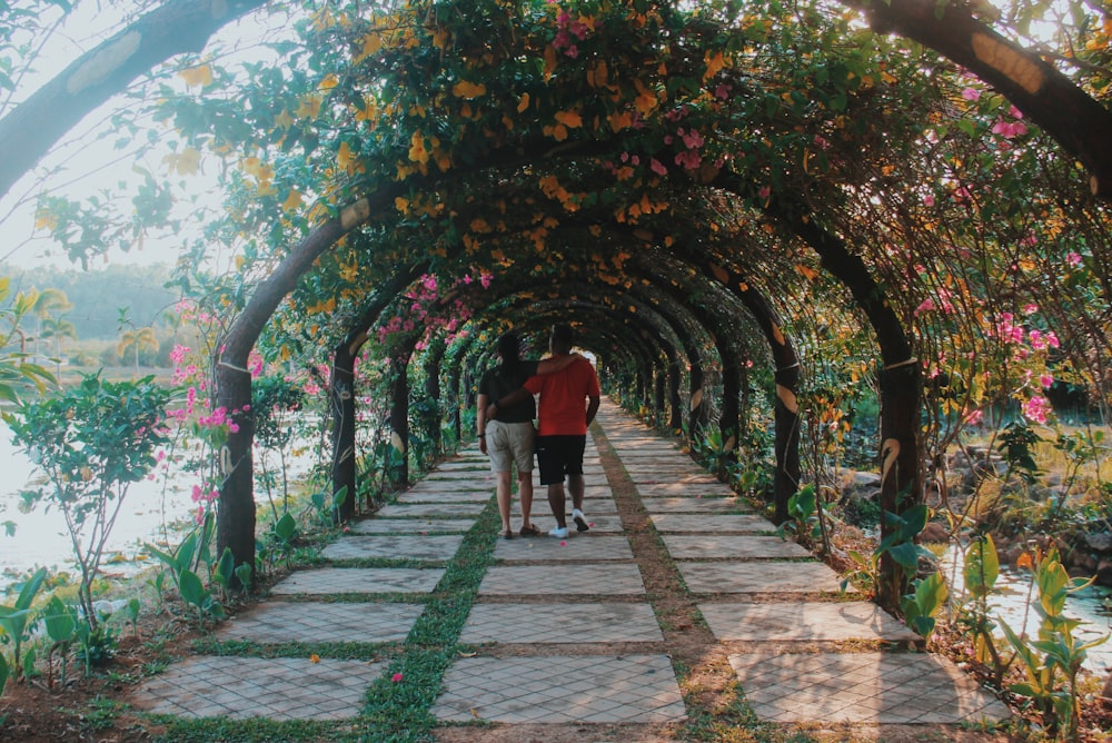 man and woman walking on pathway