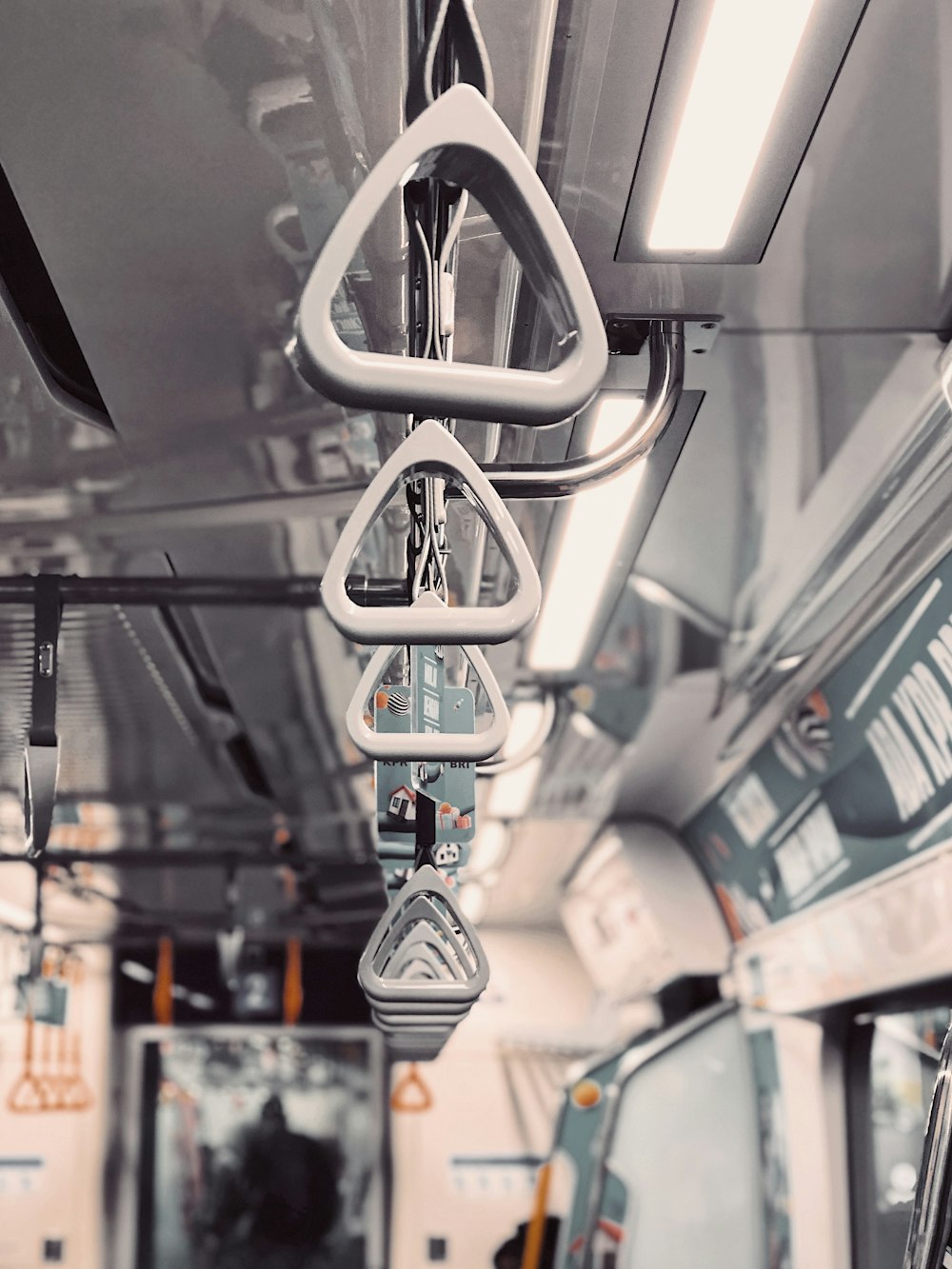 train interior with hanging support handles
