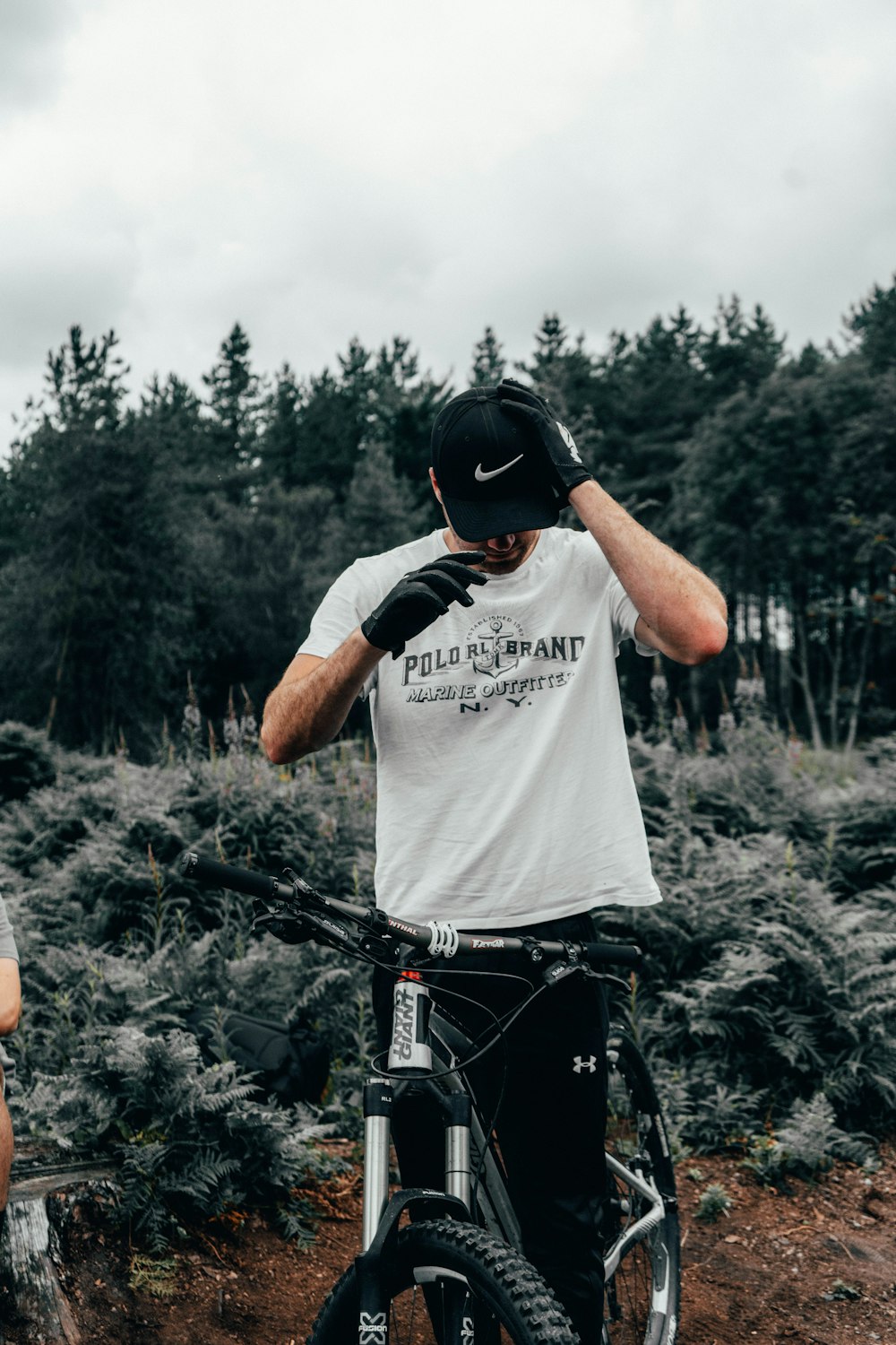 man standing with bike