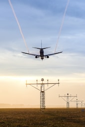 plane over electric tower