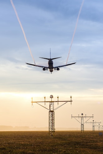 plane over electric tower