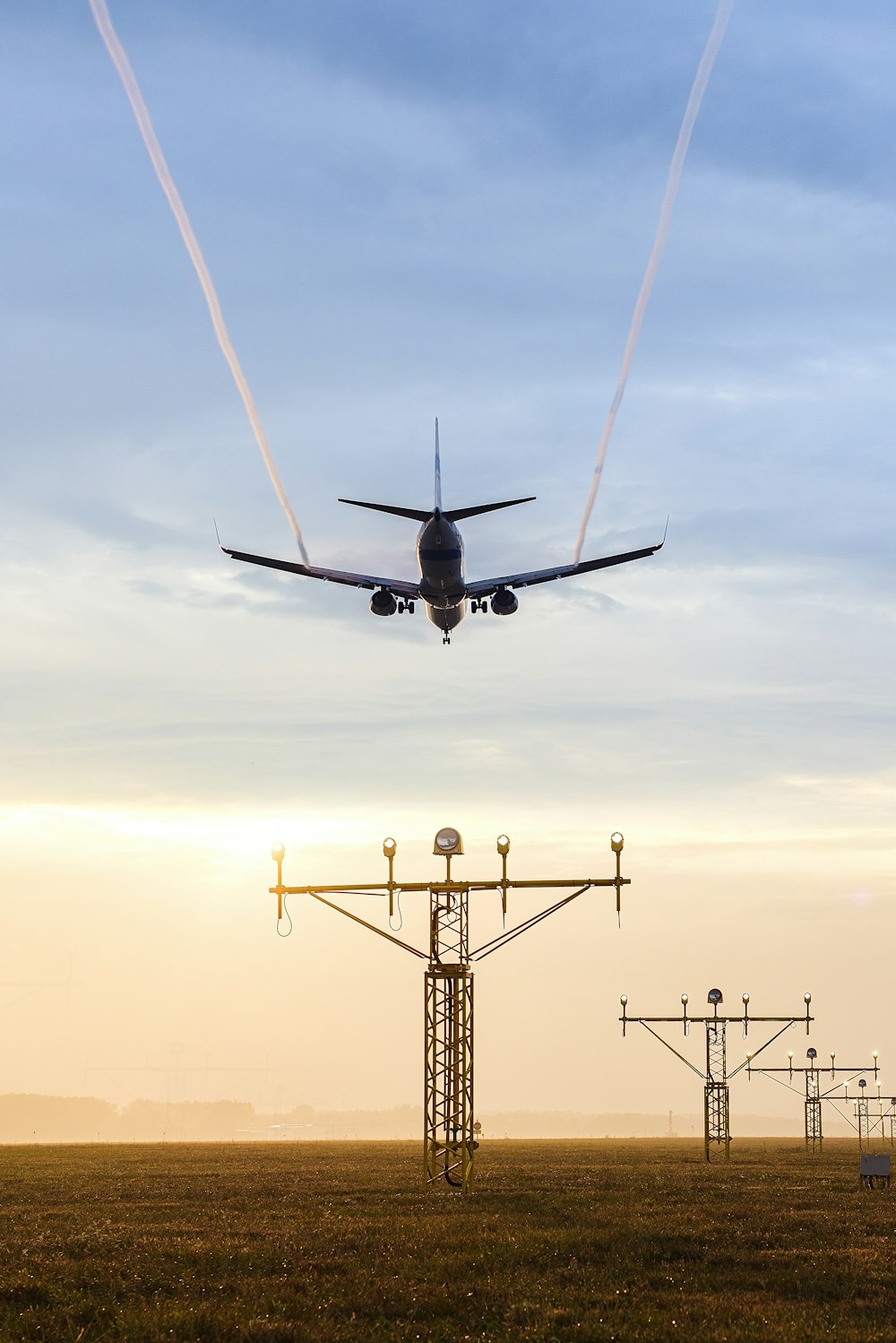 plane over electric tower