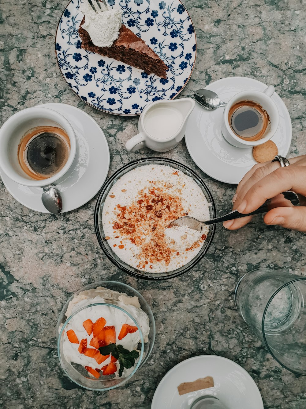 a table topped with plates of food and cups of coffee