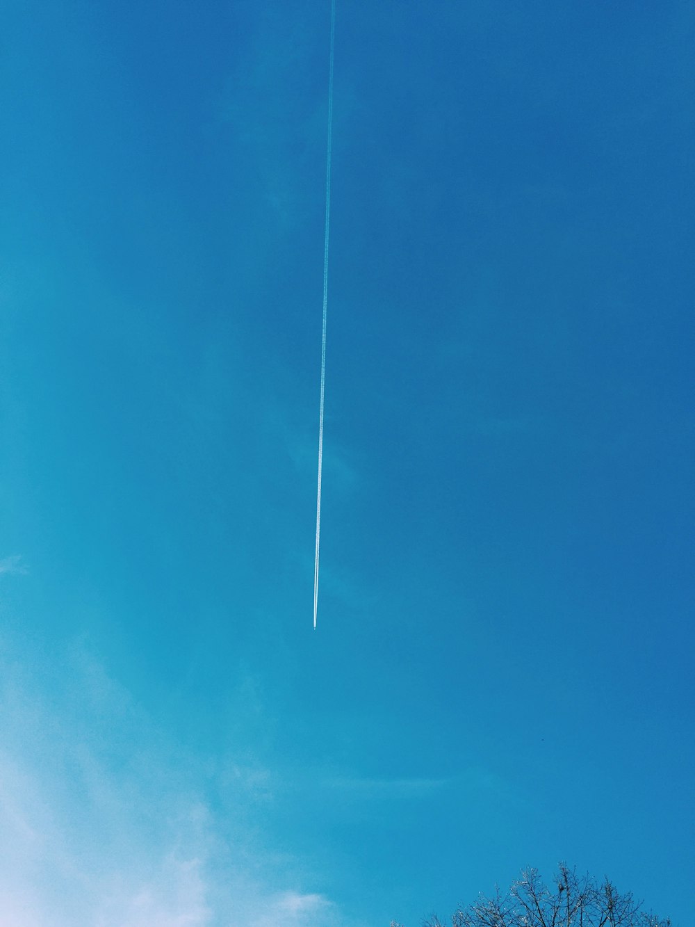 low angle view of plane contrail