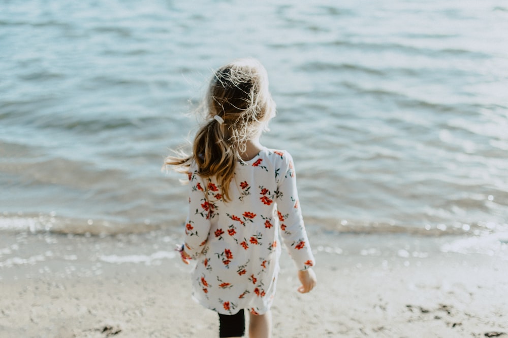 girl walking on seashore