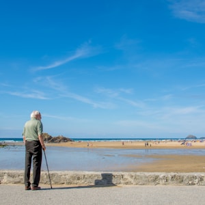 man stands and looks the low tide view of the beach