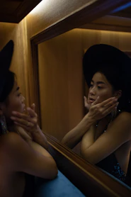 woman facing mirror