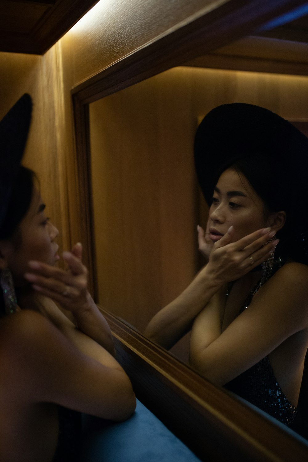 woman facing mirror