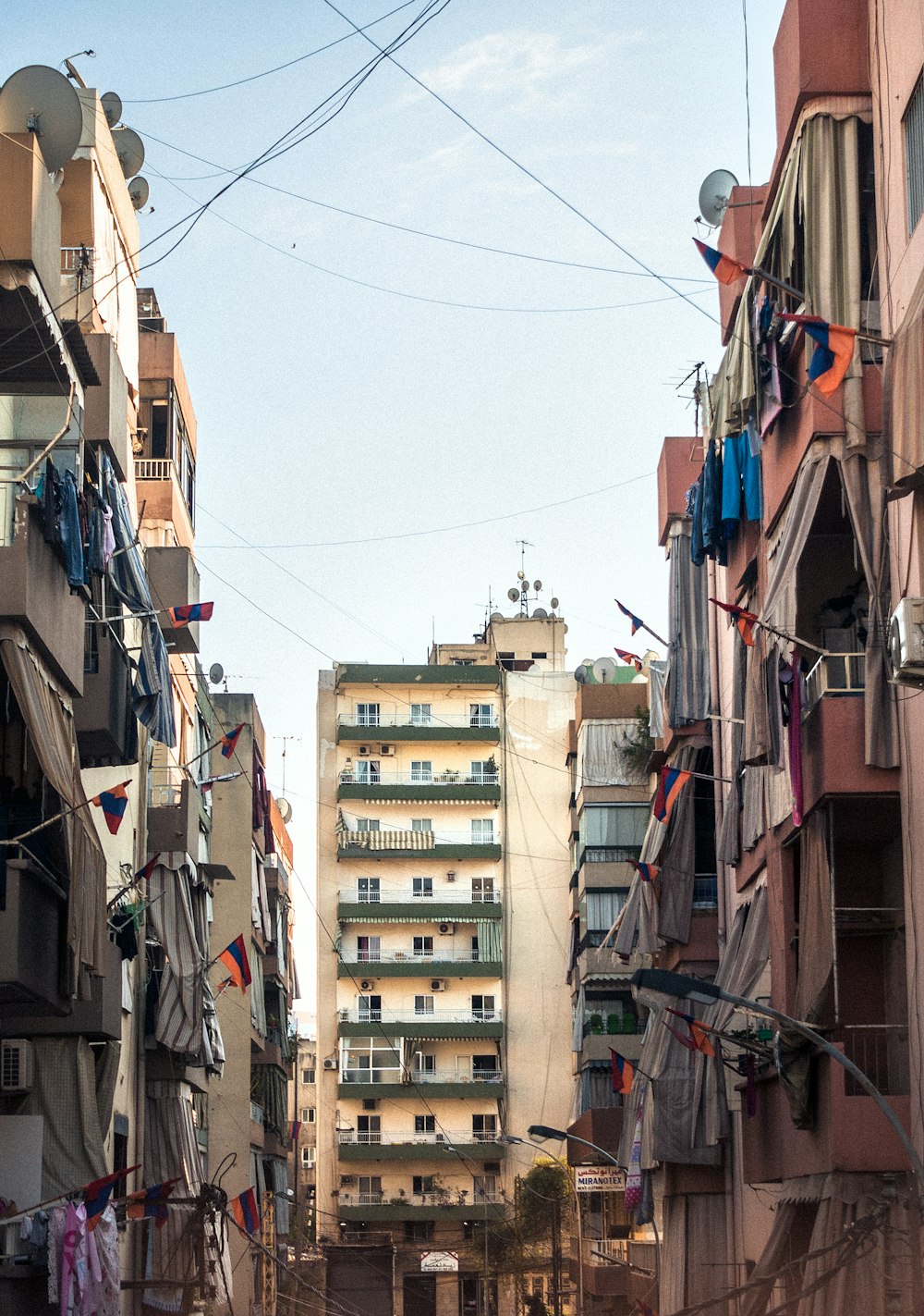 narrow street between concrete buildings