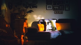 Bright and cozy living room with warm orange accents and minimalist decor in a Shanti apartment.