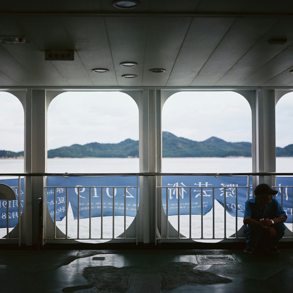 a person sitting on a boat looking out at the water