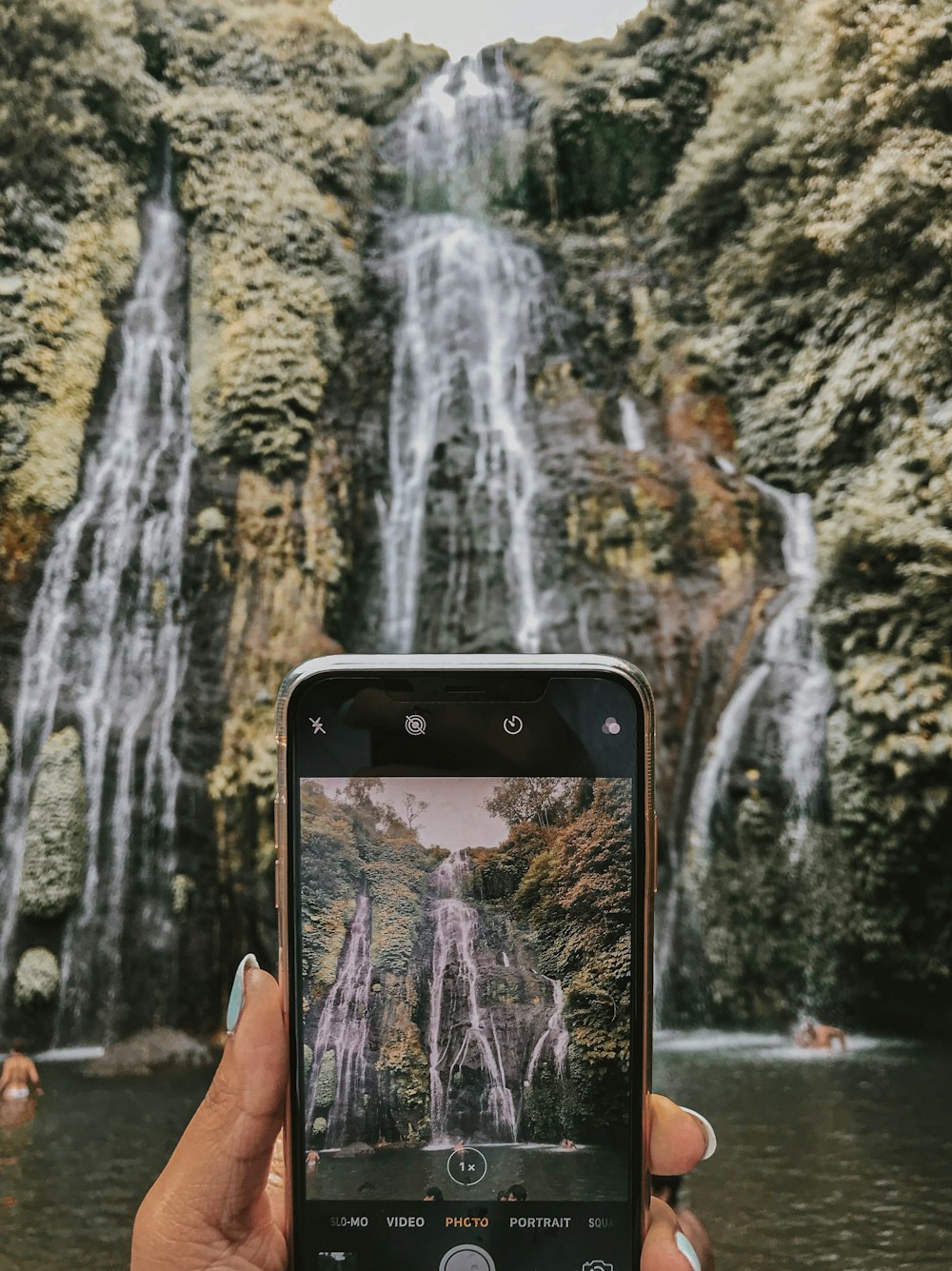 black smartphone across waterfalls
