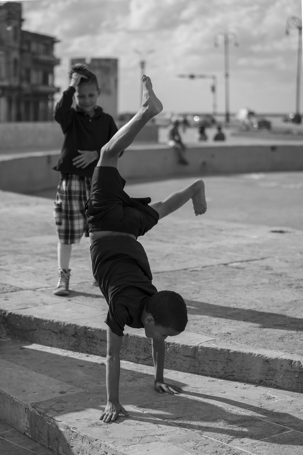 grayscale photography of boy walking with using hand