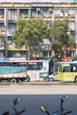 A busy urban street with delivery vehicles parked.