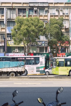 A busy urban street with delivery vehicles parked.