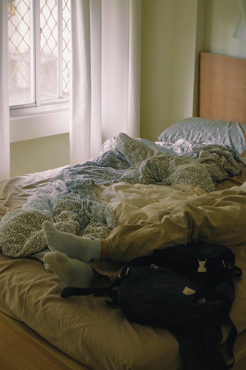 black backpack on bed