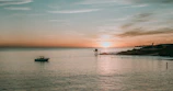 Sunset over the calm Black Sea with a silhouette of a small fishing boat