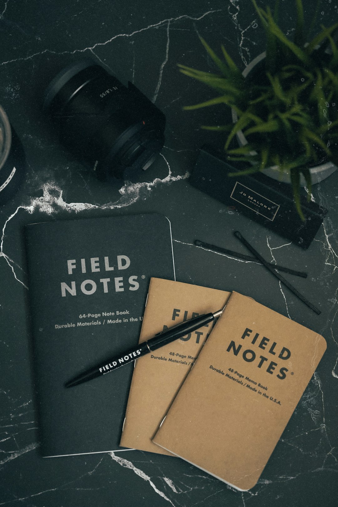 two brown and black field notes books