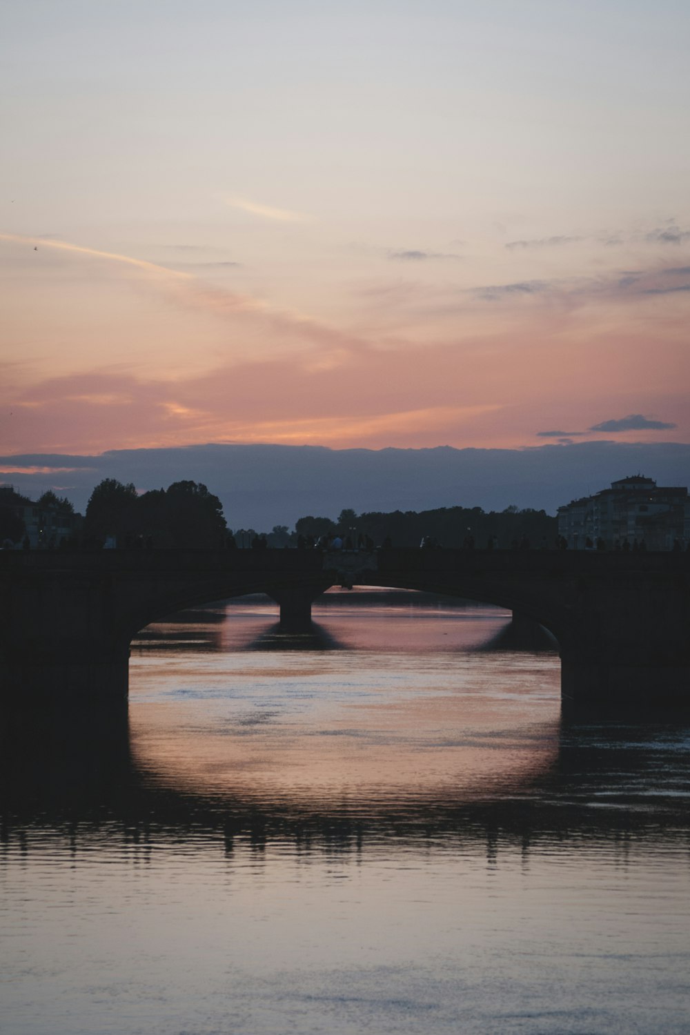 a bridge over a body of water at sunset