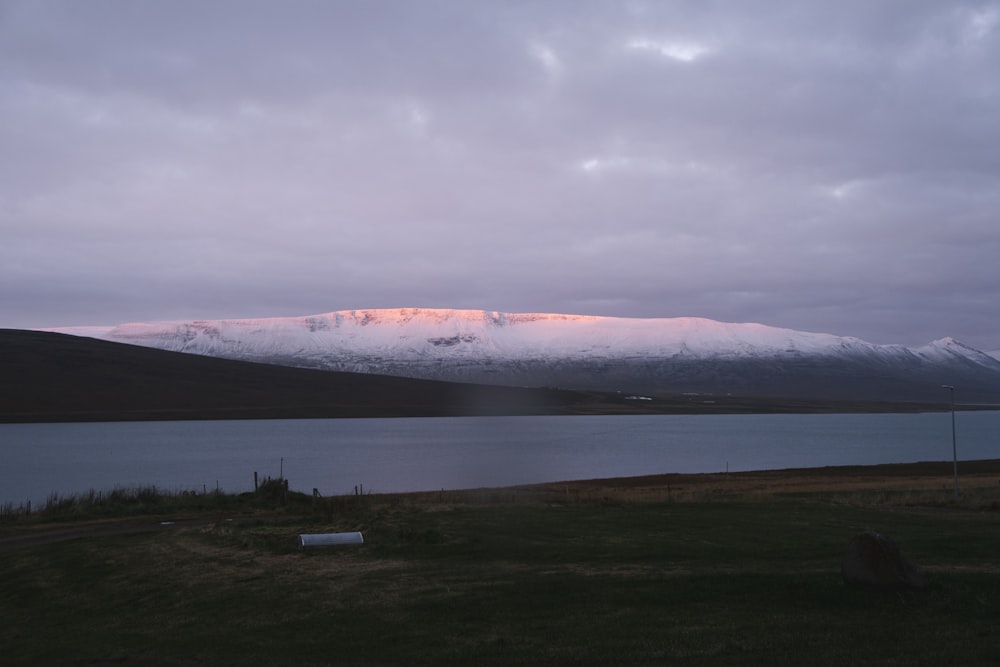 snow covered mountain under cloudy sky