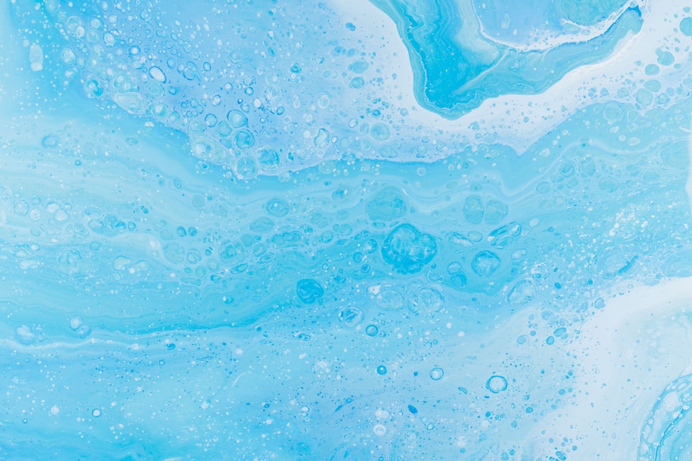 a close up of a blue and white liquid