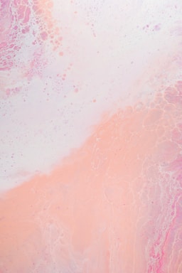 A soft blend of pastel colors with a prominent focus on pinks and whites. The texture appears marbled, with subtle swirls and bubbles creating a soothing abstract pattern.