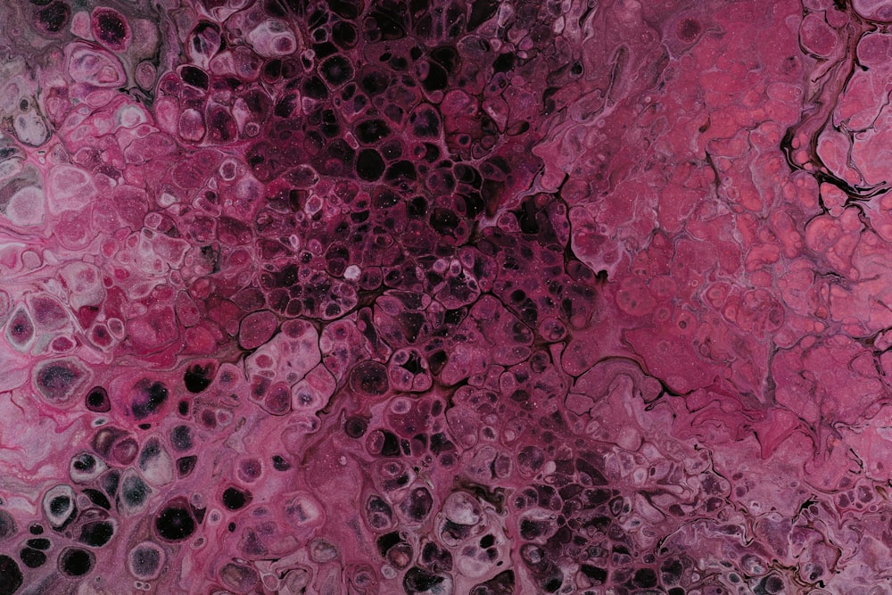 an abstract painting with pink and black colors