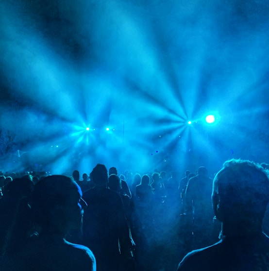 a group of people standing in front of a stage