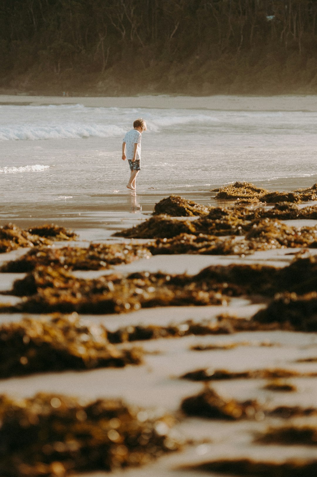 child walking near body of water during daytime