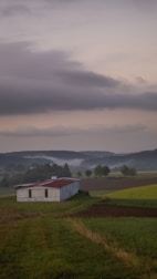 A tranquil farm landscape with fields and a rustic barn.