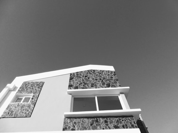 A modern building facade showcasing exposed concrete textures and finishes