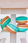 A delicate pastel macarons tower displayed elegantly on a white ceramic stand.