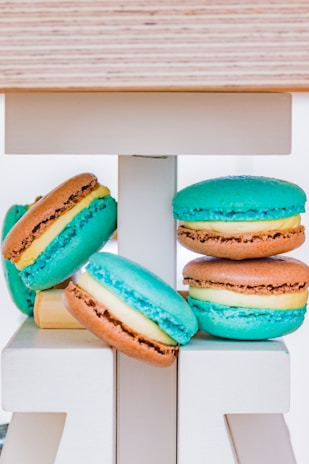 A colorful assortment of macarons stacked neatly on a pastel cake stand.