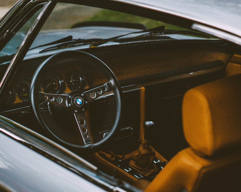 shallow focus photo of black BMW steering wheel