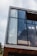 A close-up of a modern aluminum window with clear glass, showcasing craftsmanship.