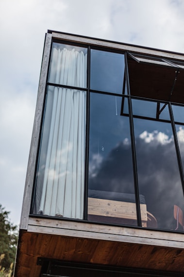 A beautifully designed modern home extension showcasing large glass windows.
