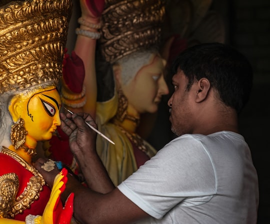 woman painting statue in Siliguri India