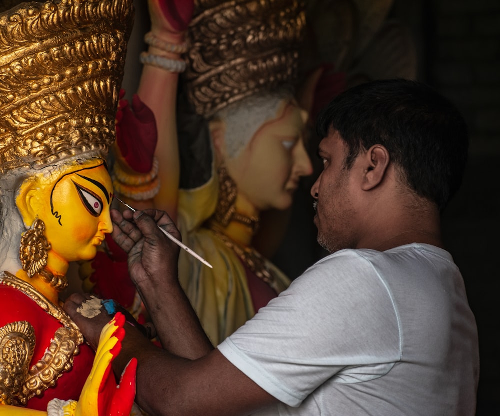 woman painting statue