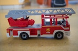 High-definition photo of Playmobil firefighters in action with their fire truck.