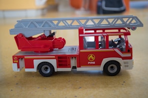High-definition photo of Playmobil firefighters in action with their fire truck.