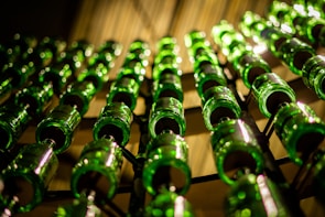 a bunch of green bottles are lined up