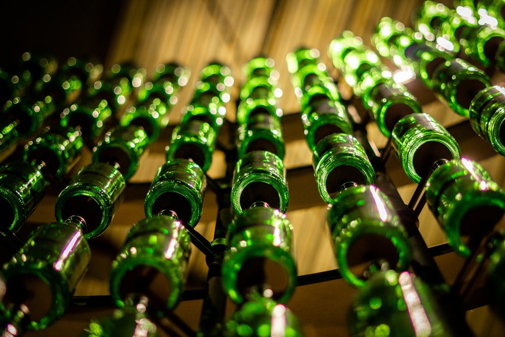 a bunch of green bottles are lined up