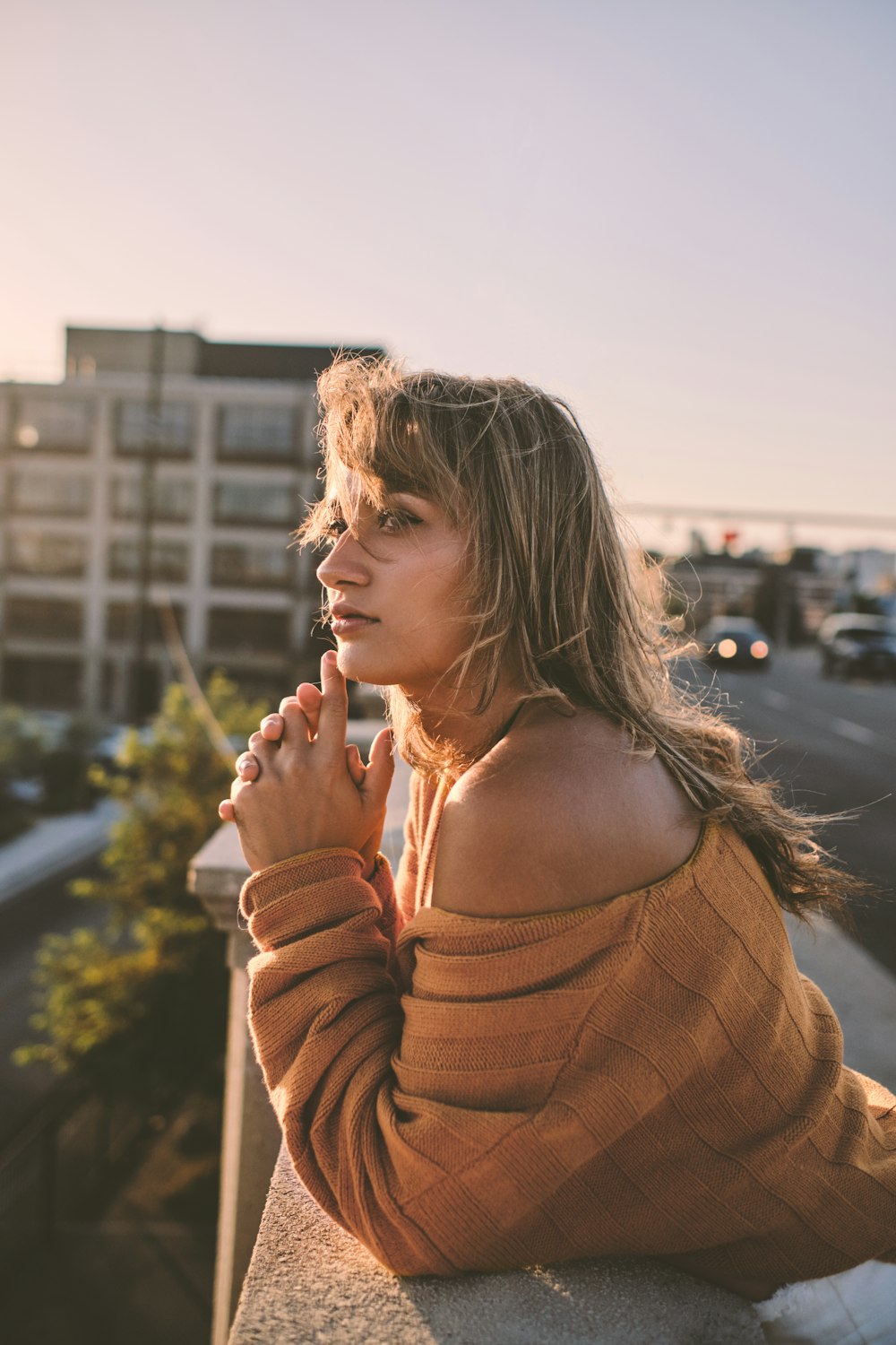 selective focus photography of woman leaning on wall