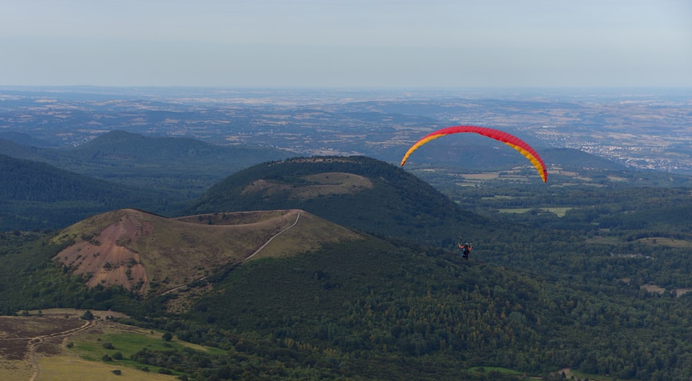 aerial-photography of person paragliding near mountain