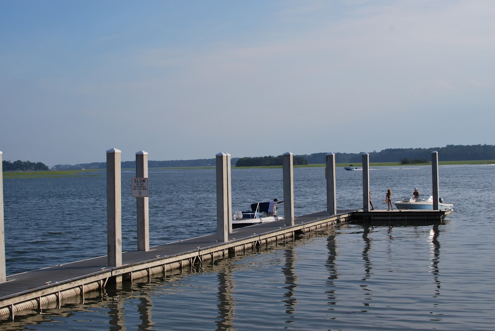 a boat is docked at a pier on the water