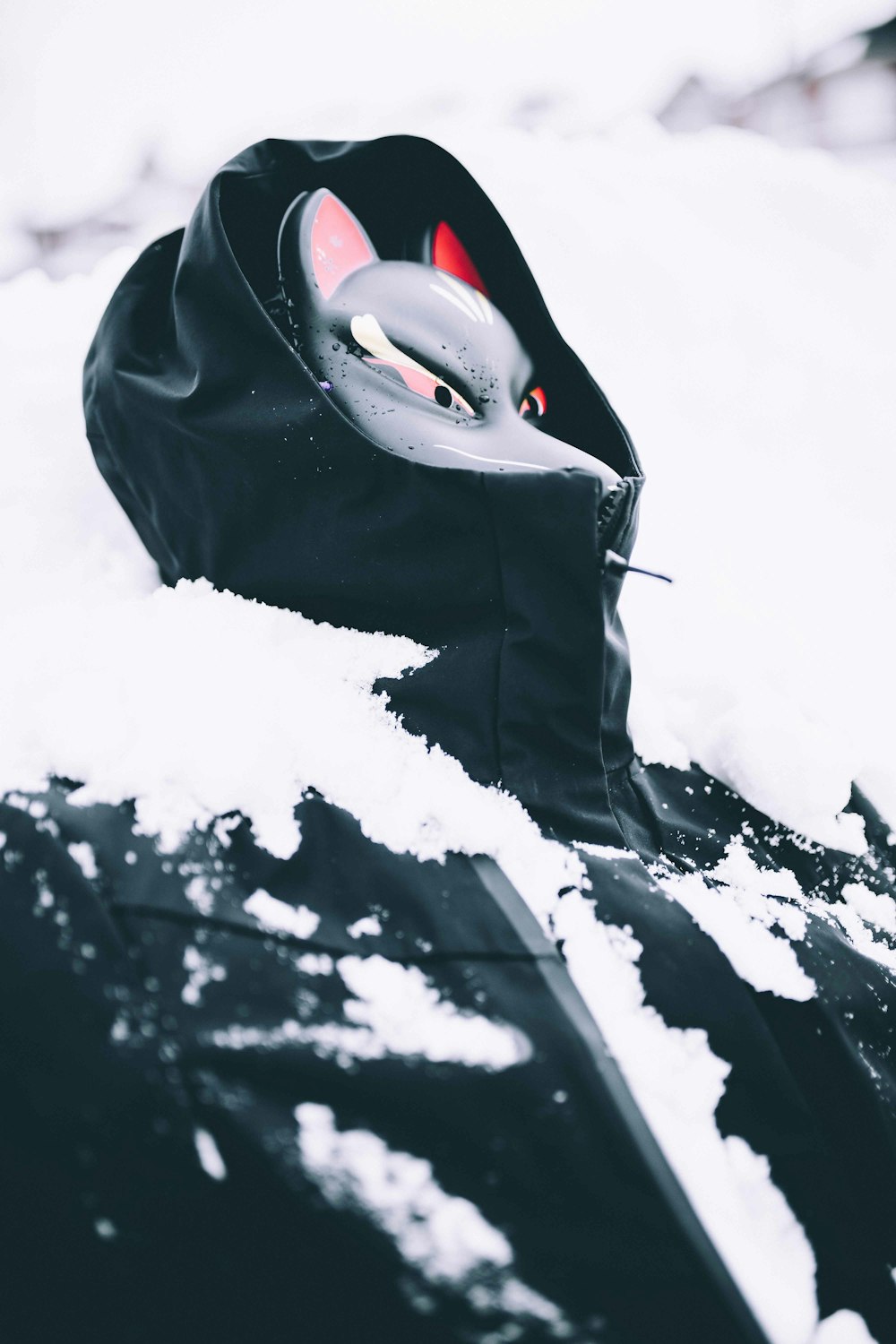 a car covered in snow with a hood up