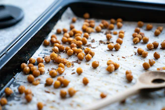 a pan filled with chickpeas and a wooden spoon